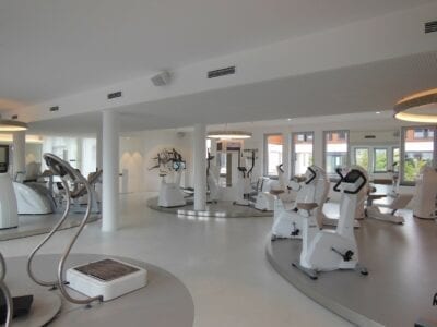 Photo of a fitness studio with white exercise equipment.