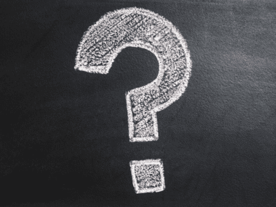 Question mark written with chalk on a chalkboard.
