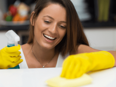 Photo of young woman smiling as she cleans.