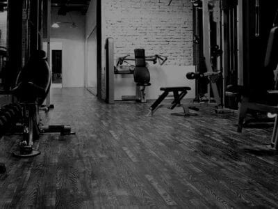 Black and white photo of a exercise equipment in a gym.