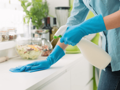 Woman wiping kitchen counter.