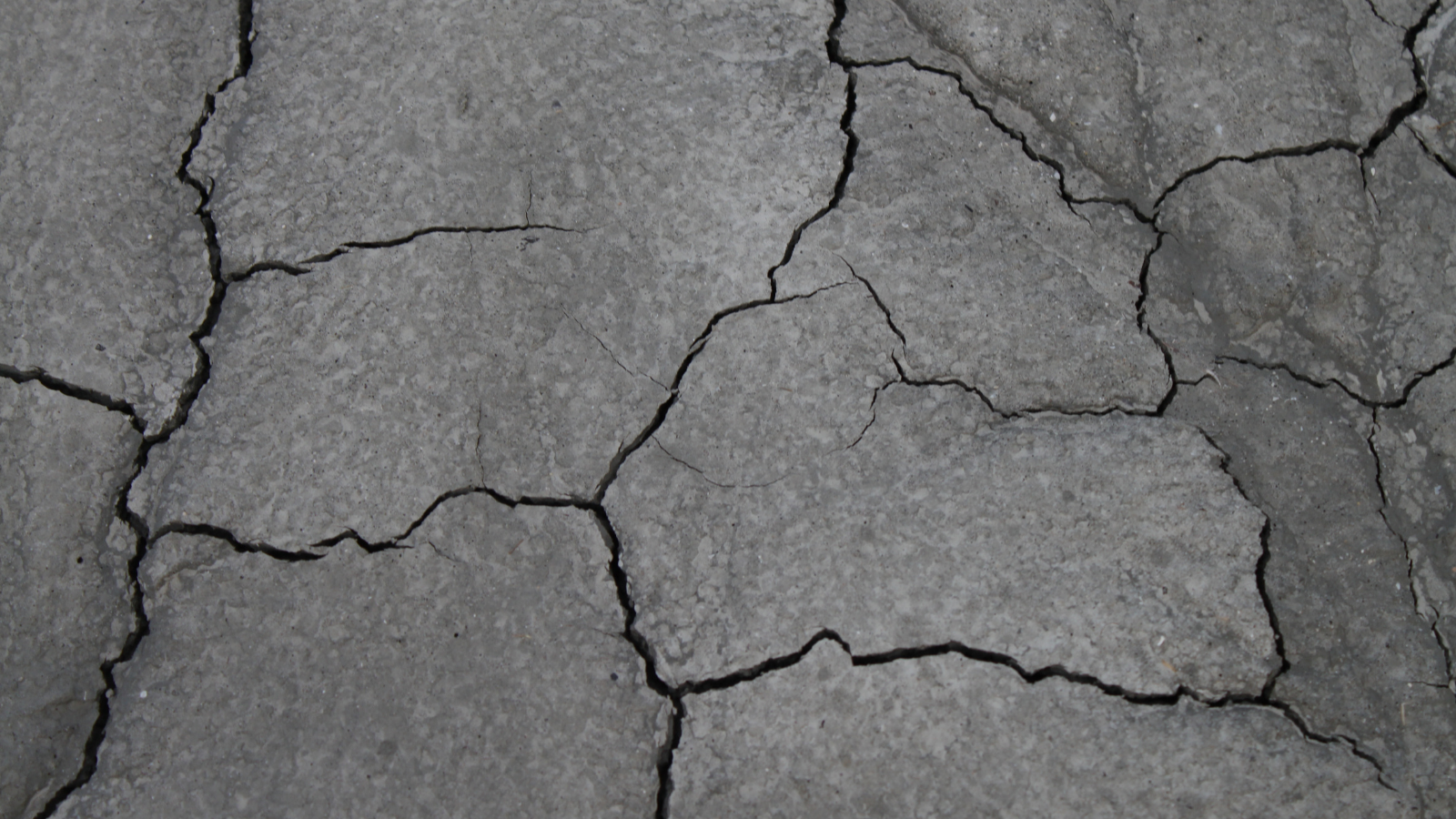 Cracking is the result of alcohol drying out the surface. Using an alcohol-based wipe or spray strips away moisture and protective coating and layers.